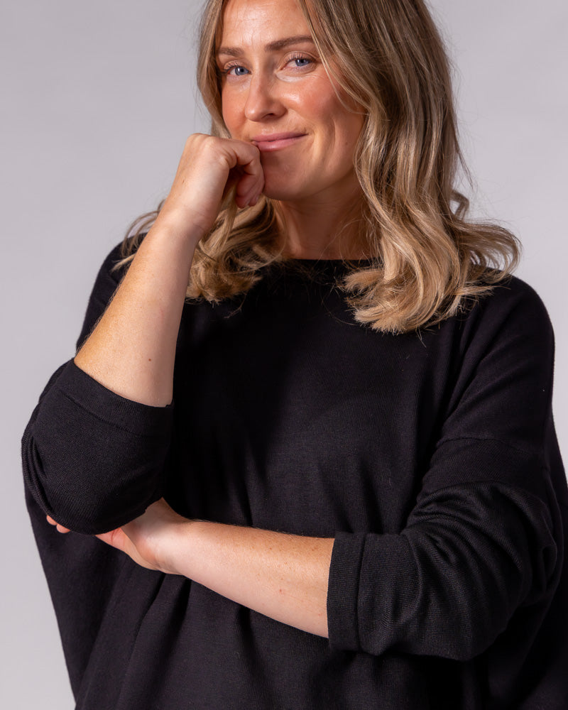 Black cotton-blend knit jumper featuring an oversized draped silhouette, crew neck, and fitted sleeves.