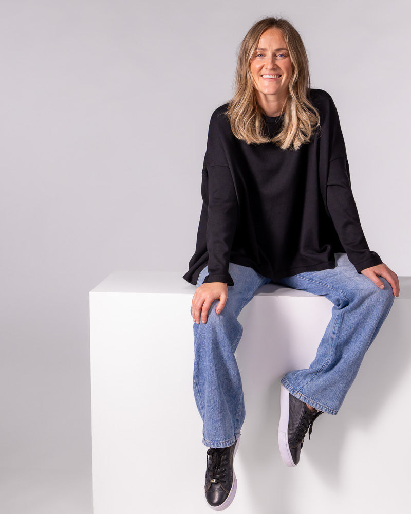 Black oversized cotton-blend knit jumper featuring a crew neckline, dropped shoulders, fitted sleeves and a draped body.