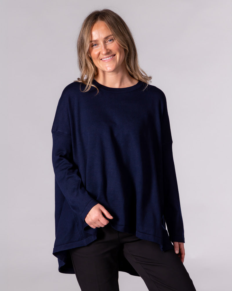 Oversized navy cotton-blend knit jumper with a classic crew neckline, long fitted sleeves and a draped high-low hem.