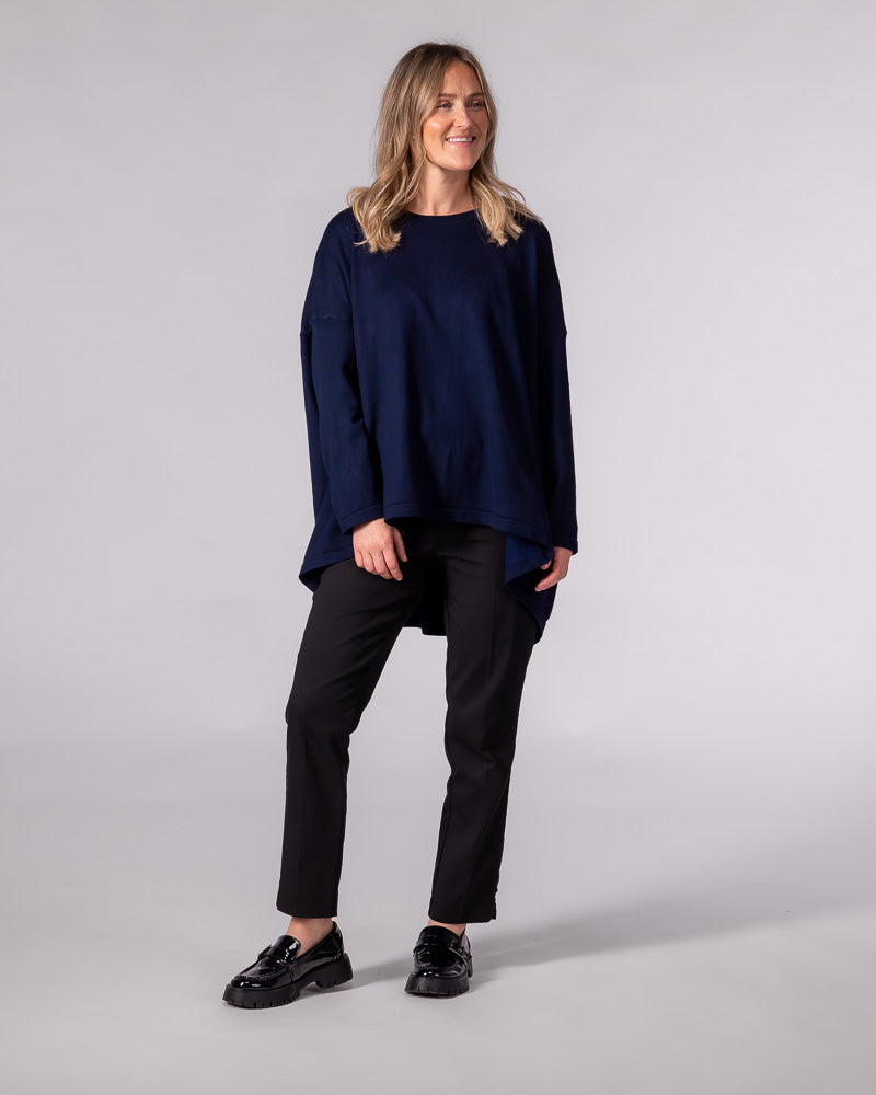Navy cotton-blend oversized knit jumper featuring a crew neckline, dropped shoulders, and a draped high-low hem.