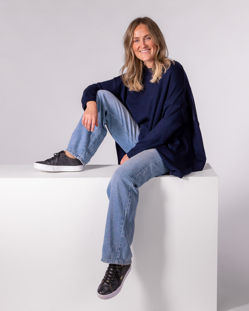 Navy oversized knit jumper featuring a crew neckline, long fitted sleeves, and a slouchy draped silhouette.