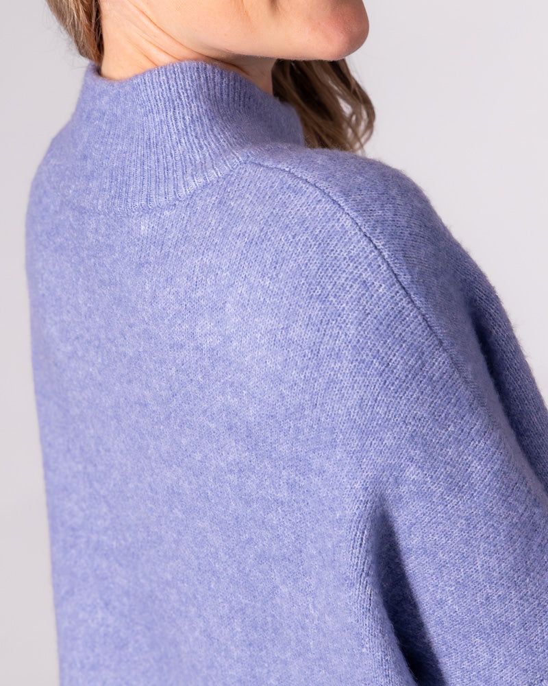 Blue brushed knit jumper featuring a ribbed funnel neck and relaxed drop shoulder seam.