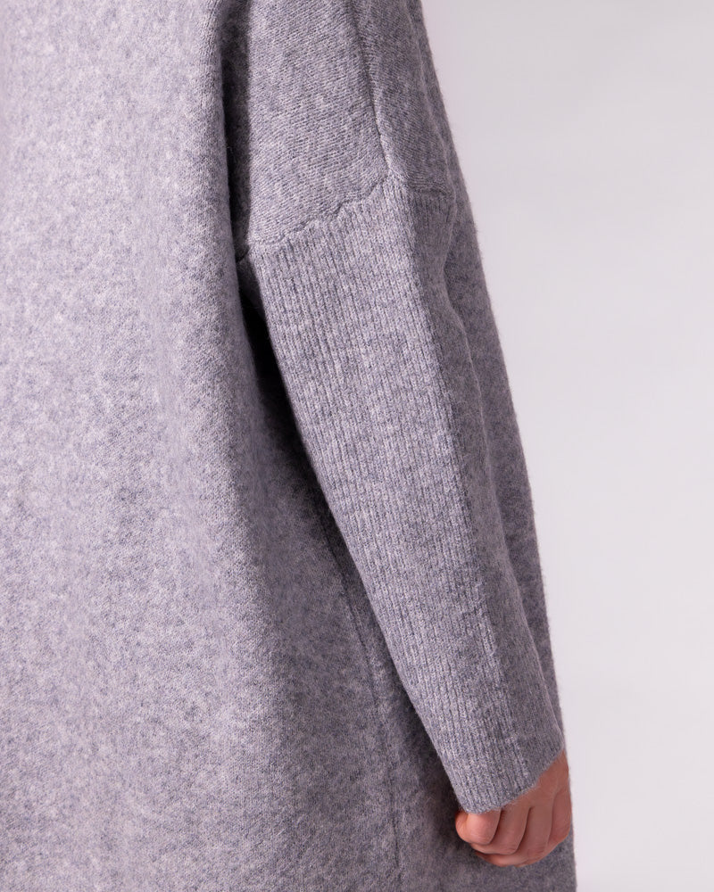 Grey brushed knit jumper highlighting the relaxed drop shoulder seam and a contrasting long ribbed sleeve.