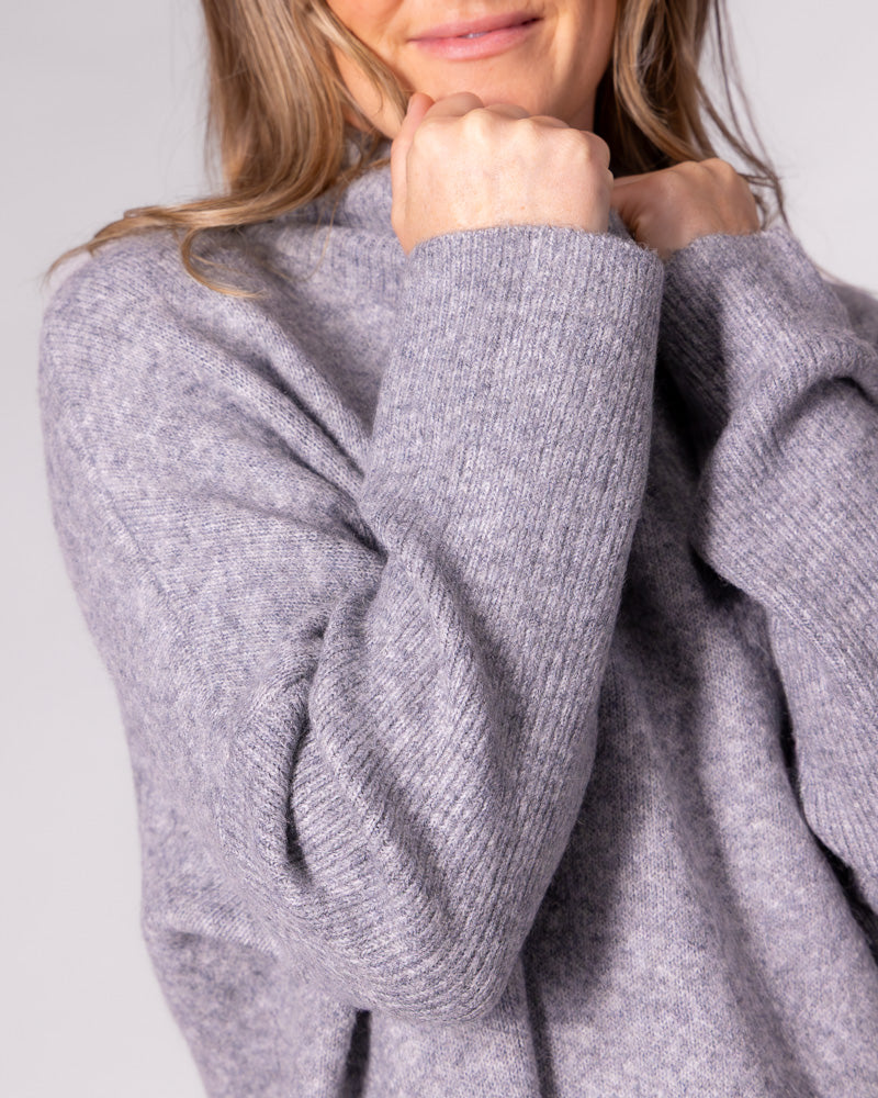 Grey oversized knit jumper featuring a soft brushed finish and prominent ribbed sleeve detail.