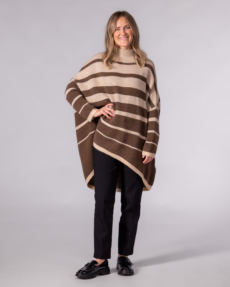 Oversized brushed knit jumper in brown stripe with a funnel neck, drop shoulders, and a draped high-low hemline.