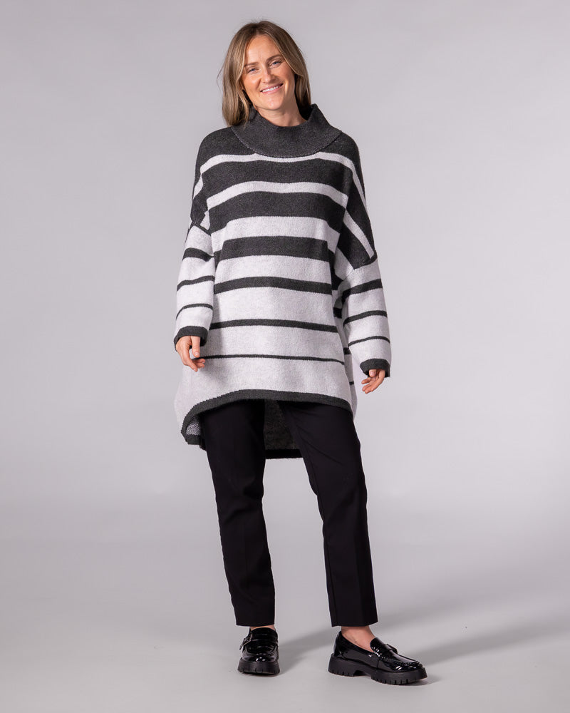 Oversized brushed knit jumper in charcoal stripe with a funnel neck, relaxed drop shoulders and a high-low hem.