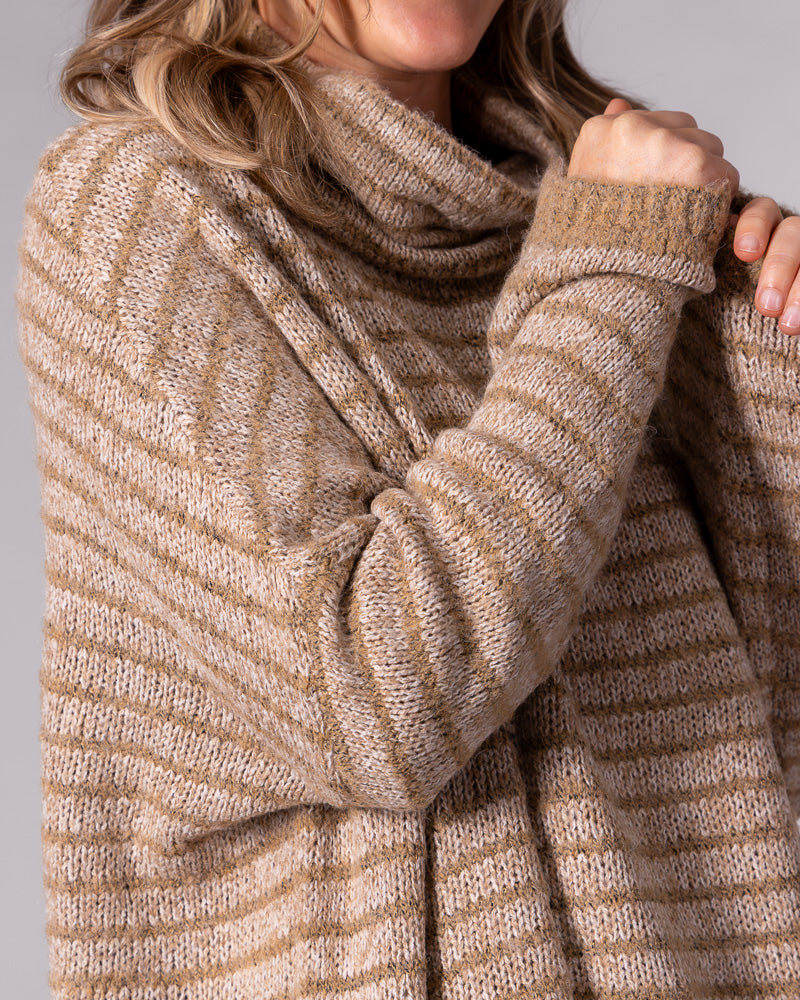 Oversized beige and mocha striped soft knit jumper featuring a draped funnel neck and relaxed drop-shoulder sleeves.