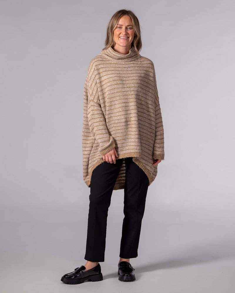 Oversized beige and mocha striped knit jumper with a relaxed funnel neck, drop shoulders, and a scooped high-low hem.