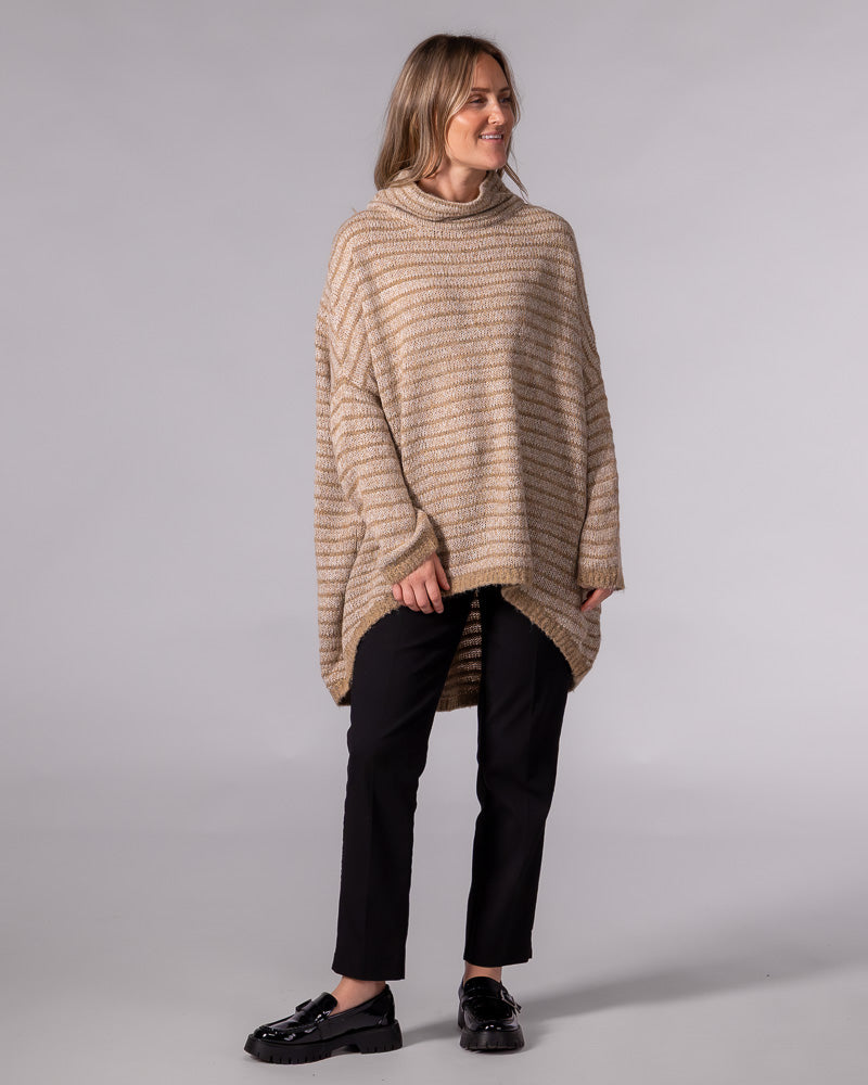Beige and mocha striped oversized knit pullover featuring a funnel neck, drop shoulders, and a scooped high-low hem.
