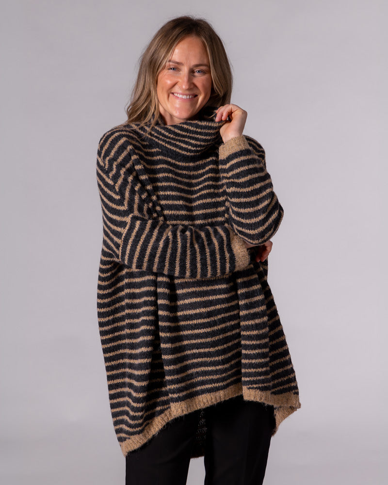 Oversized black and mocha striped brushed knit jumper with a relaxed funnel neck, drop shoulders, and scooped hem.