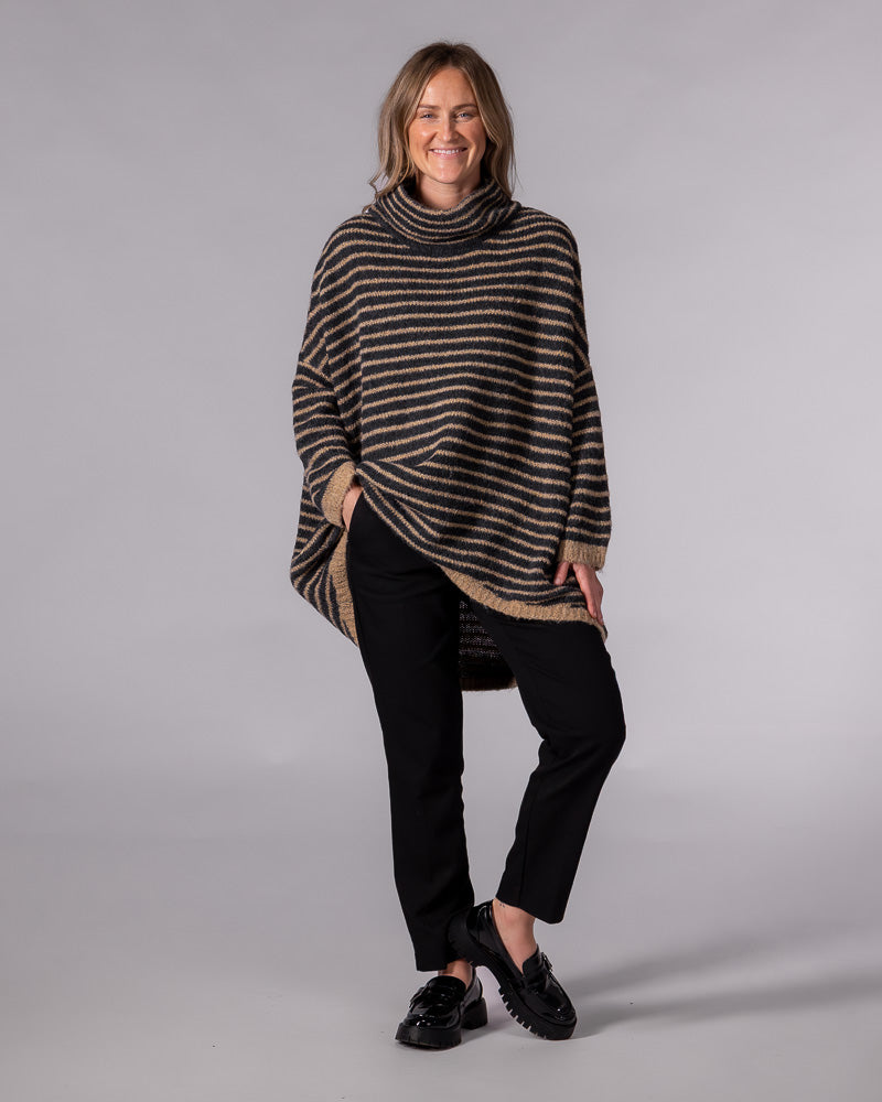 Oversized black and mocha striped knit jumper with a funnel neck, drop shoulders, and a scooped high-low hem.