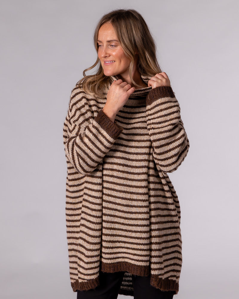 Oversized chocolate and beige striped knit jumper with a funnel neck, drop shoulders, and ribbed high-low hem.