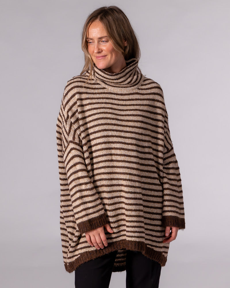 Oversized chocolate and beige striped knit jumper featuring a funnel neck, relaxed drop shoulders, and a high-low hem.