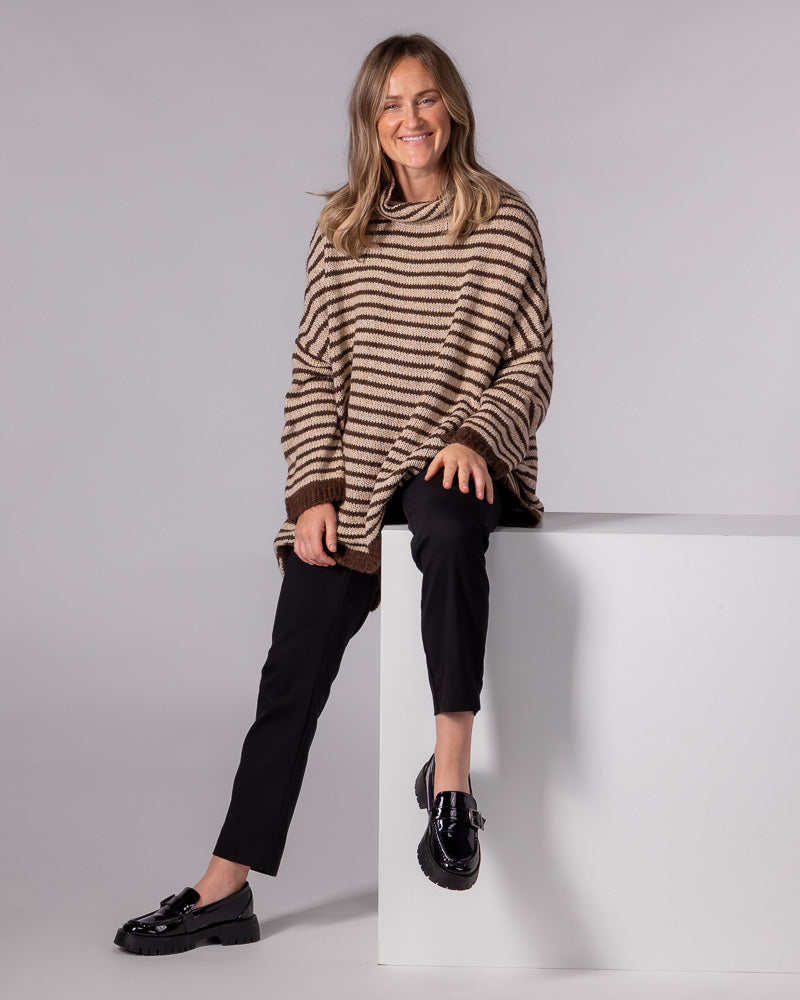 Oversized chocolate and beige striped brushed knit jumper with a funnel neck, drop shoulders, and solid brown cuffs.