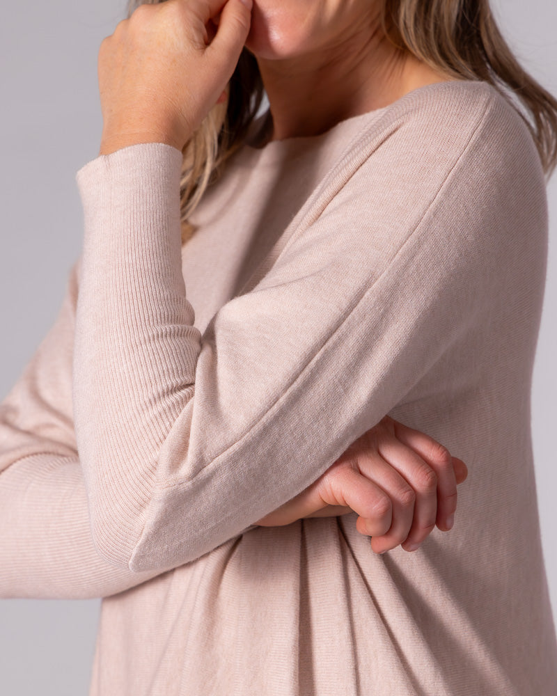 Blush cotton knit jumper with a wide boat neckline, dropped shoulder seam, and a fitted ribbed sleeve.