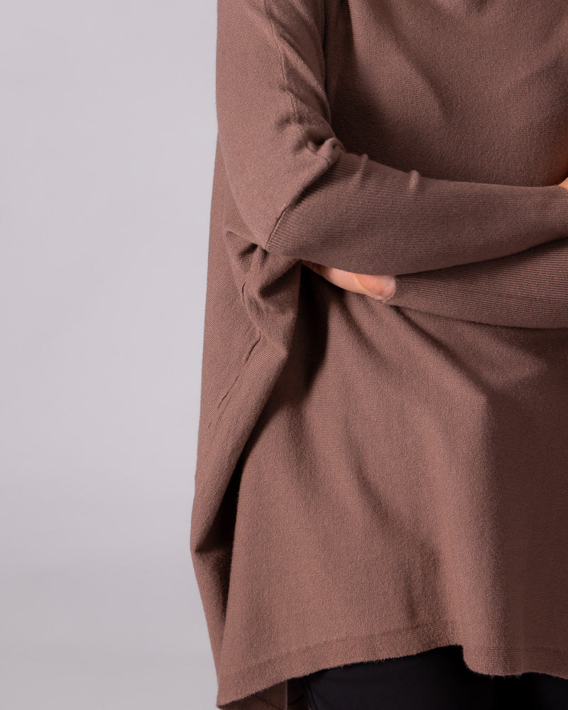 Brown cotton knit jumper displaying an oversized draped body, dropped shoulder seam, and contrasting fitted lower sleeve.