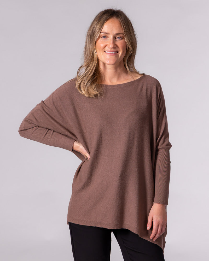 Oversized brown cotton jumper featuring a wide boat neckline, drop shoulders, and long fitted ribbed sleeves.