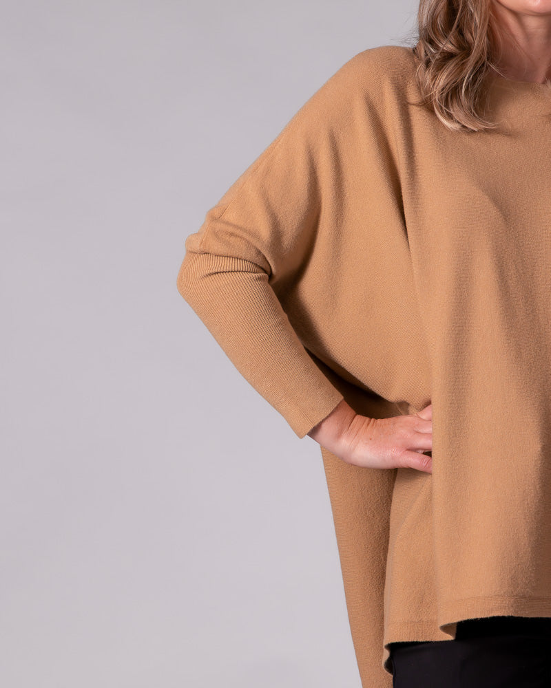 Camel cotton knit jumper with an oversized draped body, drop shoulder, and contrasting fitted ribbed sleeve.