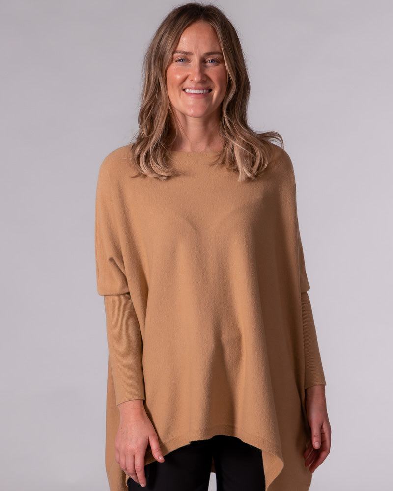 Oversized camel cotton jumper with a wide boat neckline, drop shoulders, fitted ribbed sleeves, and a hi-low hem.