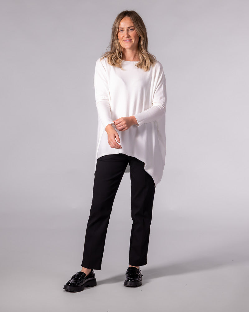 Oversized cream cotton knit jumper with a wide boat neckline, drop shoulders, fitted sleeves and draped hi-low hem.
