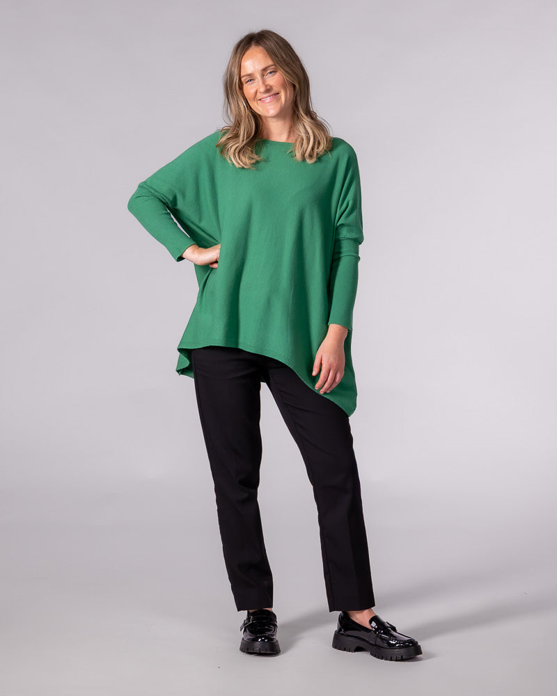 Oversized green cotton jumper with a wide boat neckline, drop shoulders, fitted sleeves and a draped hi-low hem.