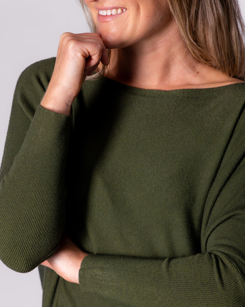 Close-up of the khaki cotton knitwear, displaying the wide boat neckline, soft texture, and long fitted sleeves.