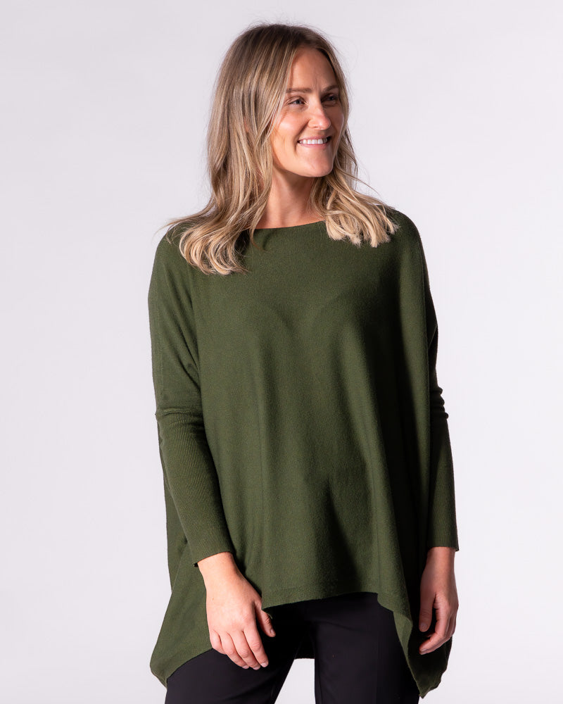 Front view of the relaxed khaki jumper, showcasing the hi-low hemline sitting noticeably higher at the front.