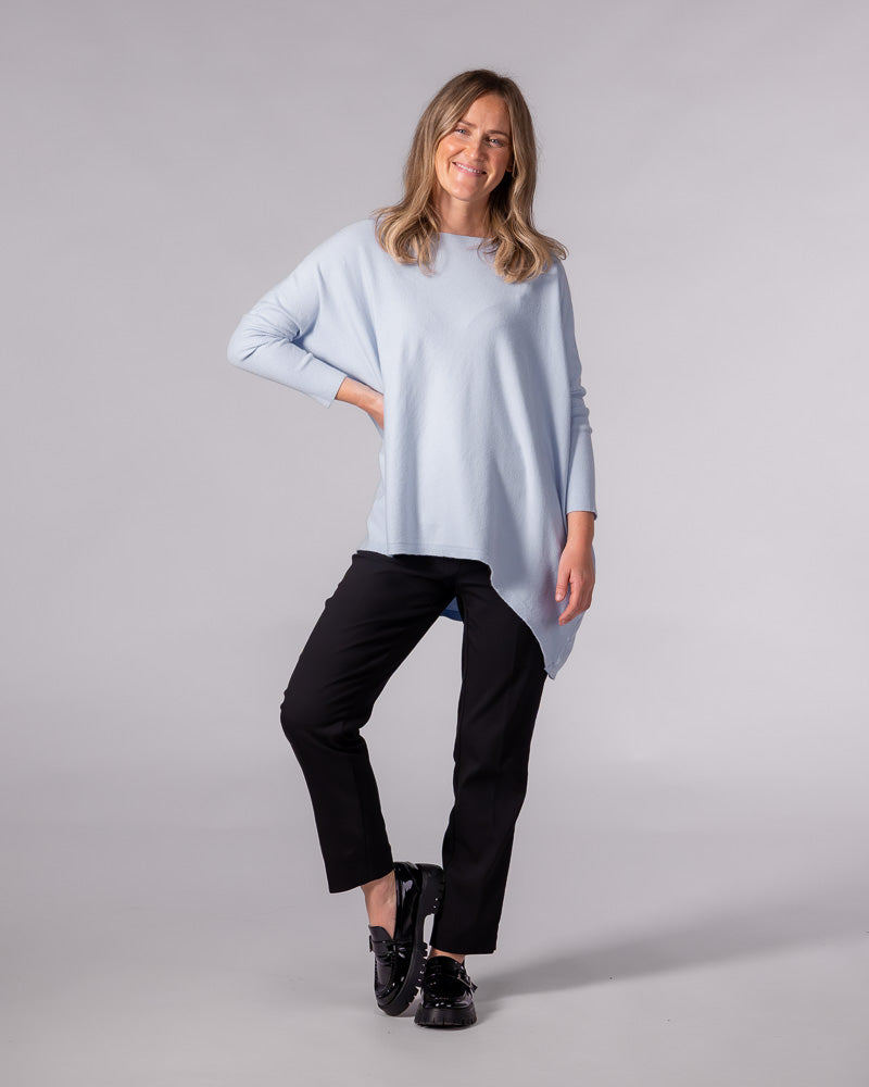 Light blue oversized cotton knit jumper featuring a wide boat neckline, drop shoulders, and long fitted sleeves.