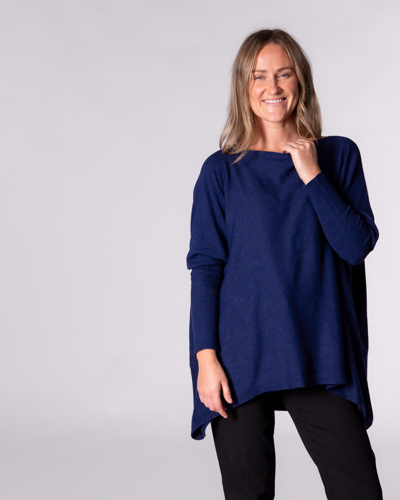 Front facing view of the navy jumper showcasing the hi-low hemline sitting noticeably higher at the front.