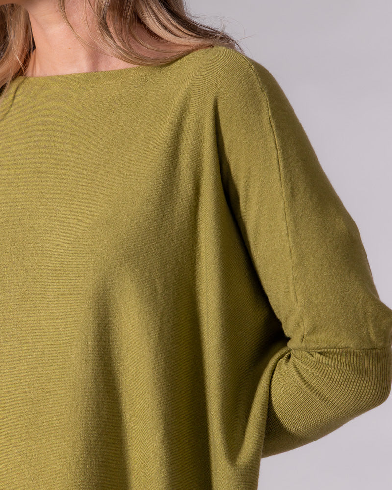 Olive green cotton knit jumper showing the wide boat neckline, relaxed drop shoulder, and fitted ribbed sleeve.