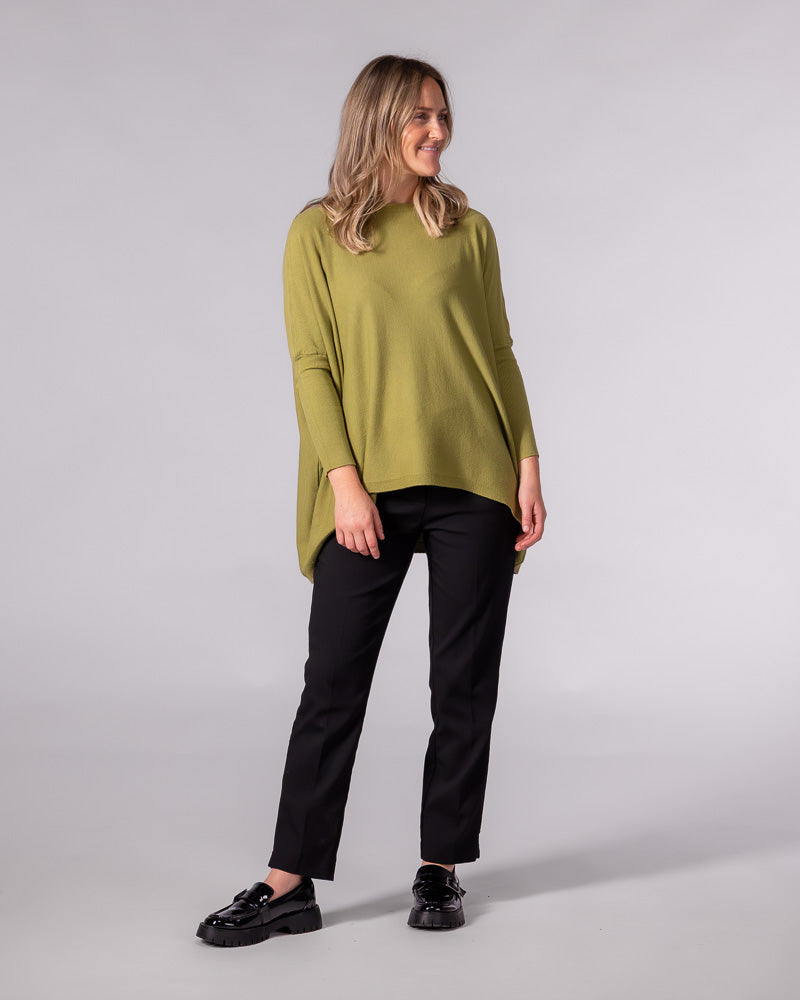 Oversized olive green cotton knit jumper featuring a wide boat neckline, fitted sleeves, and a draped hi-low hem.