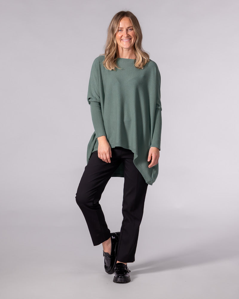 Oversized sage green cotton knit jumper featuring a wide boat neckline, fitted sleeves, and a draped hi-low hem.