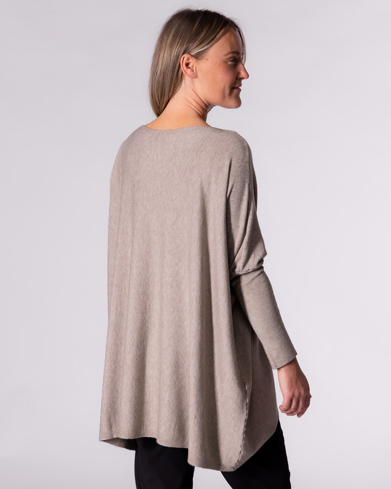 Rear angle of the Karma Kameleon taupe jumper, highlighting the extended drape back hemline and relaxed fit.