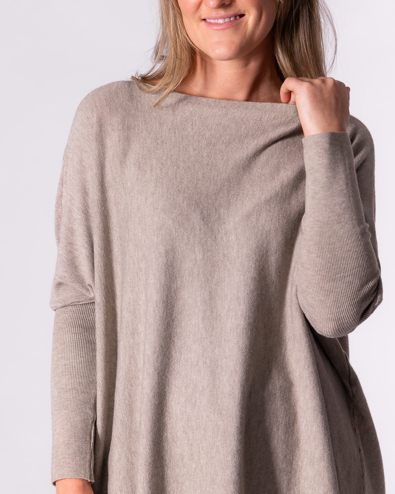Detail view of the relaxed taupe jumper capturing the comfortable drop shoulders and clean front neckline.