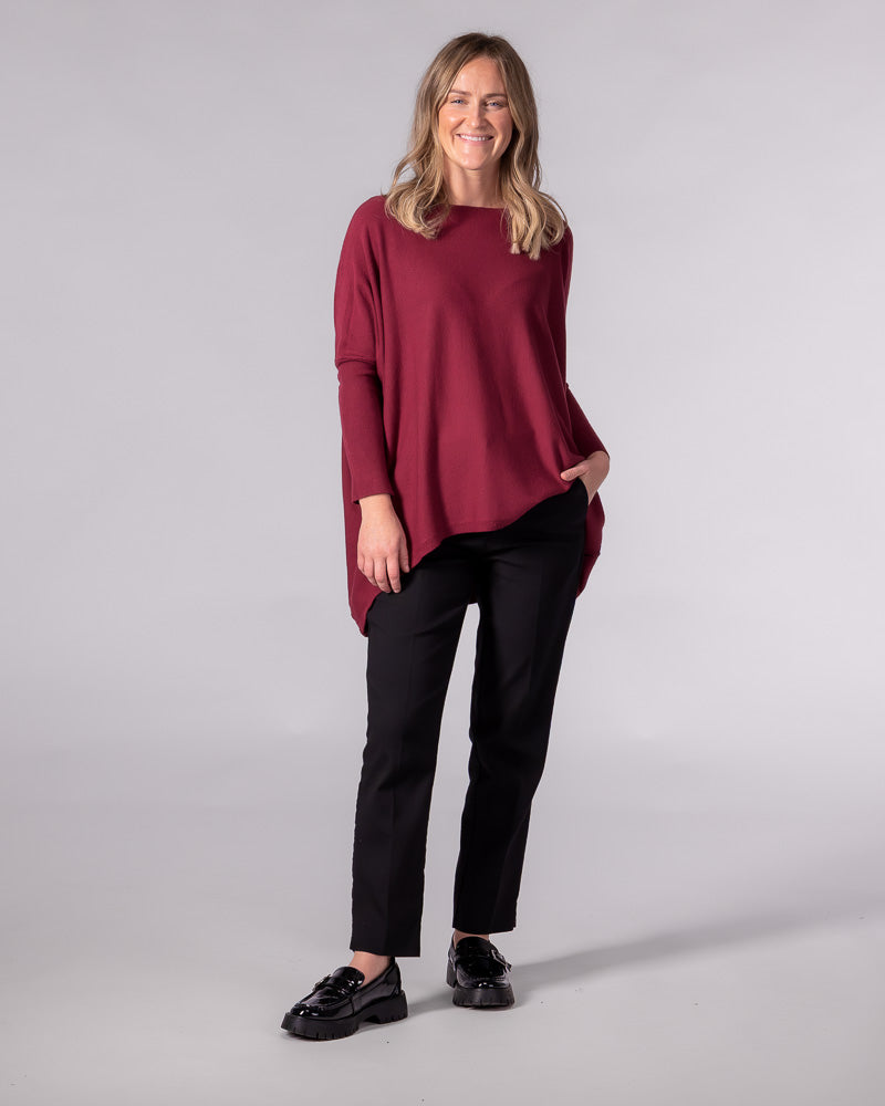 Oversized wine red cotton jumper featuring a wide boat neckline, drop shoulders, and fitted long sleeves.